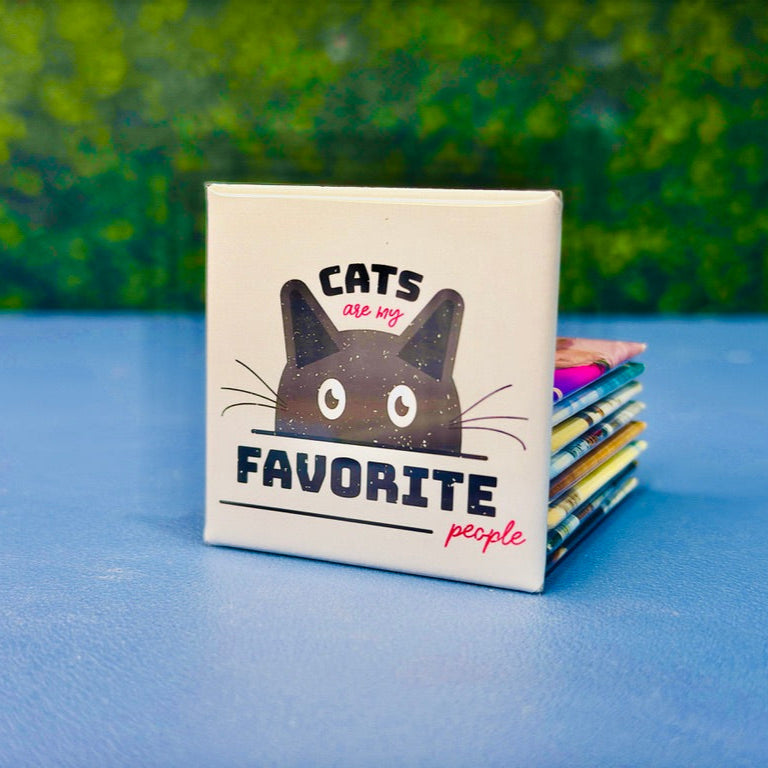 Square cat magnet featuring a bold black cartoon cat peeking up under the phrase “Cats Are My Favorite People” in playful black and red fonts. A cute and cheeky gift for cat lovers, pet moms, or anyone who’d choose a feline over a human any day. Perfect for fridge decor, office spaces, lockers, or as a funny stocking stuffer. A must-have for anyone proudly obsessed with their cats.