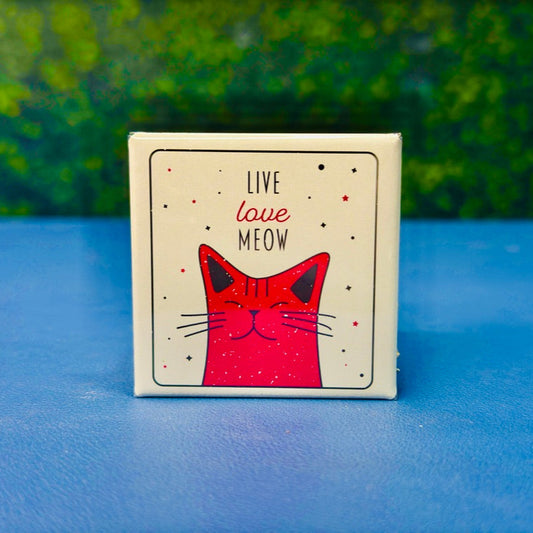 Retro-style square magnet featuring a happy pink cartoon cat surrounded by stars and the phrase “Live Love Meow.” A sweet and playful gift for cat lovers, cat moms, and pet owners who adore cute feline-themed decor. The distressed design adds a vintage touch, making it perfect for fridges, lockers, or office boards. Great as a gift, stocking stuffer, or everyday cat affirmation.