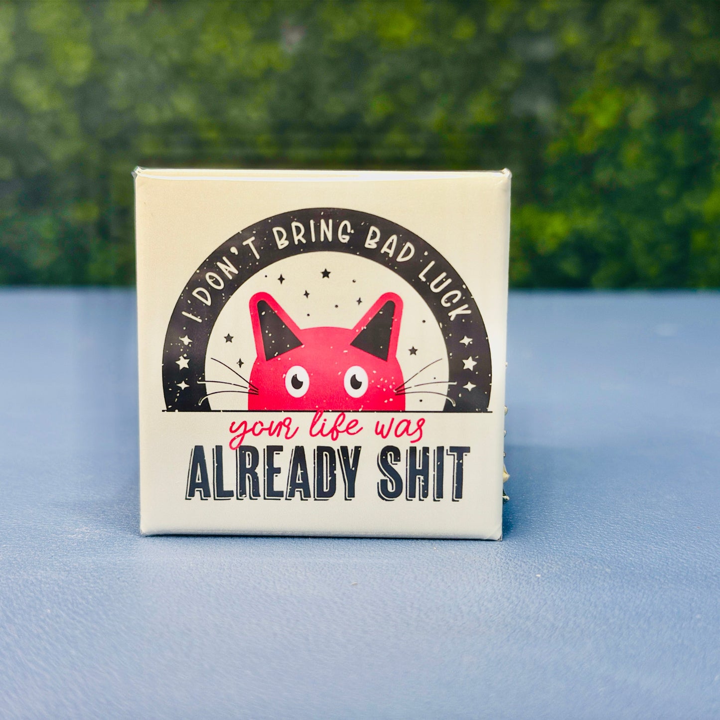 Square magnet featuring a distressed-style red cat illustration under the phrase “I Don’t Bring Bad Luck – Your Life Was Already Sh*t.” A funny, sarcastic, dark humor cat magnet for those with a twisted sense of humor. Ideal gift for cat lovers who appreciate edgy quotes, passive-aggressive fridge decor, or a gag gift for friends. Perfect for fridges, lockers, office spaces, or dorm rooms.