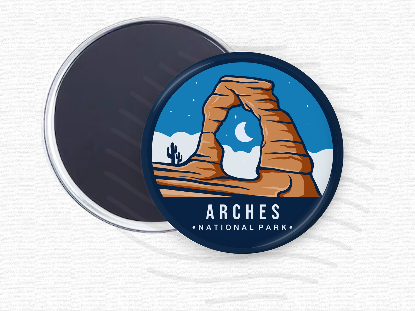 Arches National Park magnet – 2.5” round fridge magnet featuring an illustration of Delicate Arch under a starry sky with desert landscape and cacti. Magnet back partially shown. A great souvenir for hikers, desert explorers, and national park enthusiasts.