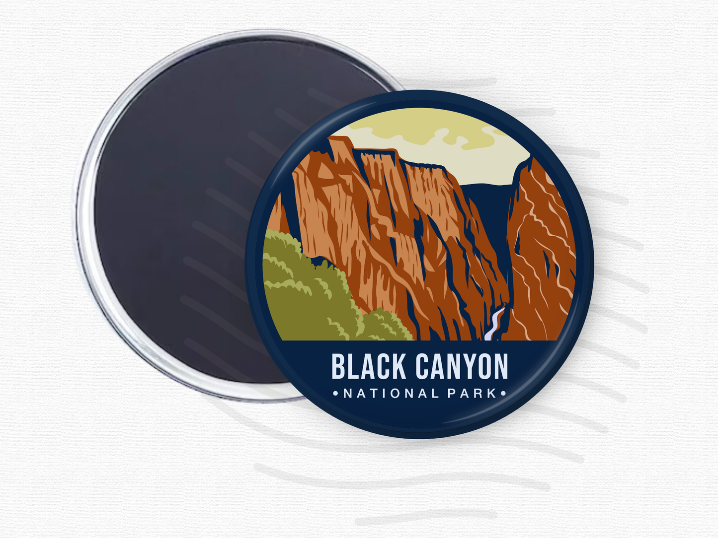 Round magnet featuring Black Canyon of the Gunnison National Park with steep red rock cliffs, green foliage, and a dramatic vertical gorge.