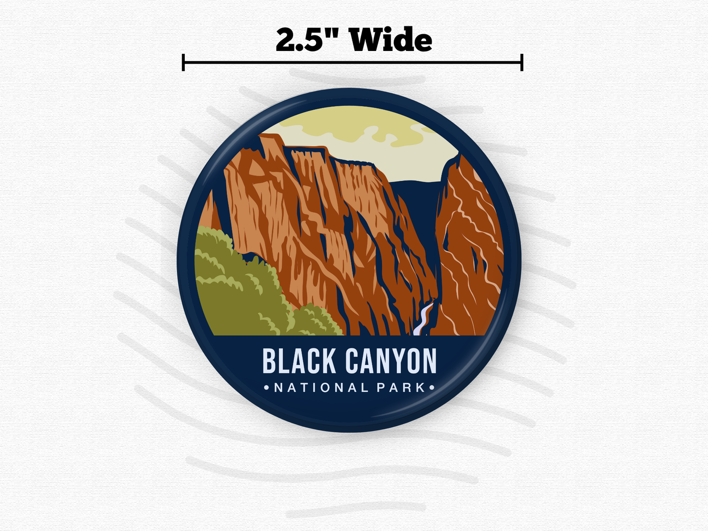 Round magnet featuring Black Canyon of the Gunnison National Park with steep red rock cliffs, green foliage, and a dramatic vertical gorge.