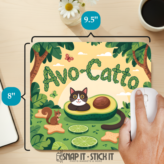 Mouse pad with avocado and cat design on a desk with a hand using a mouse.