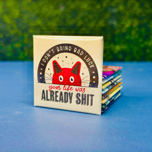 Square magnet featuring a distressed-style red cat illustration under the phrase “I Don’t Bring Bad Luck – Your Life Was Already Sh*t.” A funny, sarcastic, dark humor cat magnet for those with a twisted sense of humor. Ideal gift for cat lovers who appreciate edgy quotes, passive-aggressive fridge decor, or a gag gift for friends. Perfect for fridges, lockers, office spaces, or dorm rooms.