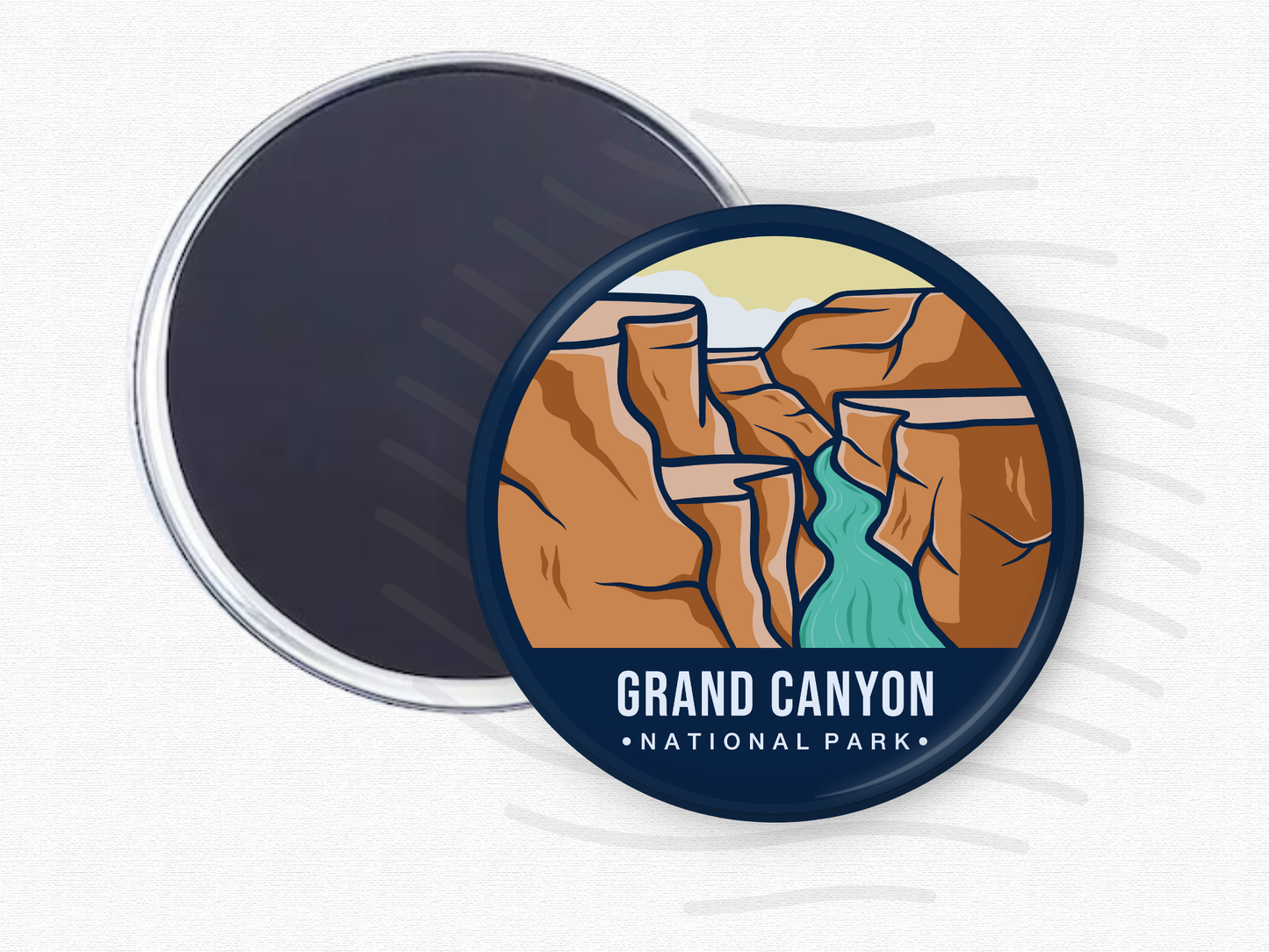 Round magnet of Grand Canyon National Park depicting layered red rock canyons with a turquoise river winding through the center under a light sky.