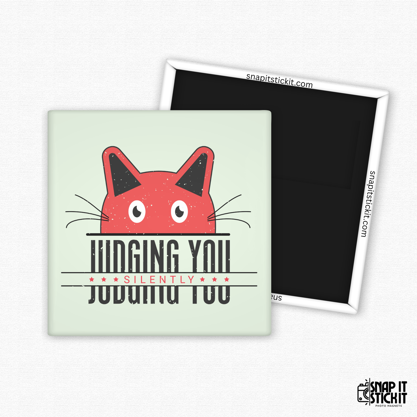 Fridge magnet with a red cat face design and text on a light green background