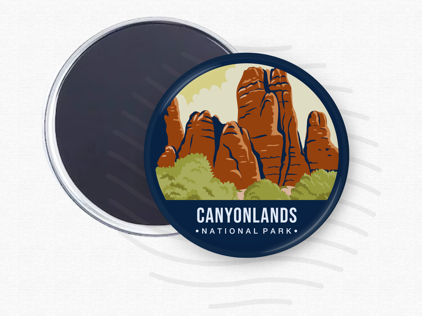 Round magnet featuring Canyonlands National Park with towering red rock formations and green shrubs beneath a light yellow sky.