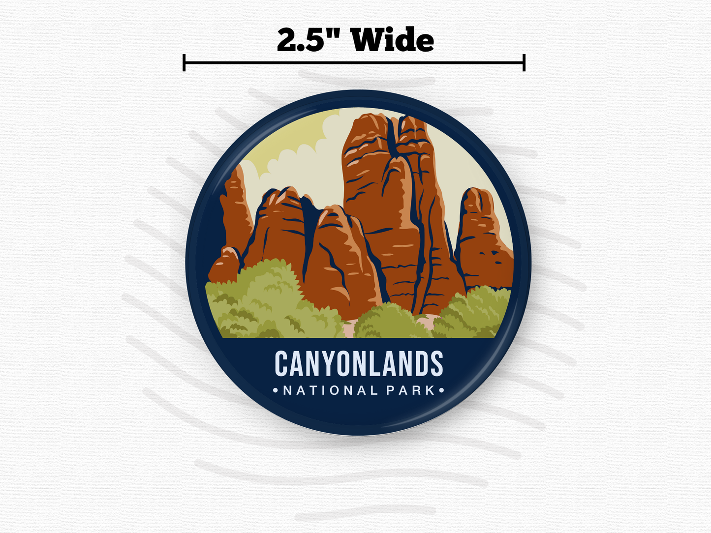 Round magnet featuring Canyonlands National Park with towering red rock formations and green shrubs beneath a light yellow sky.
