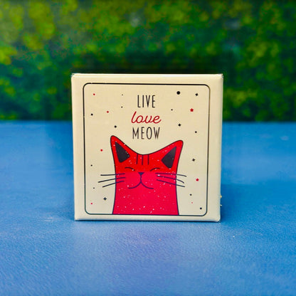 Retro-style square magnet featuring a happy pink cartoon cat surrounded by stars and the phrase “Live Love Meow.” A sweet and playful gift for cat lovers, cat moms, and pet owners who adore cute feline-themed decor. The distressed design adds a vintage touch, making it perfect for fridges, lockers, or office boards. Great as a gift, stocking stuffer, or everyday cat affirmation.
