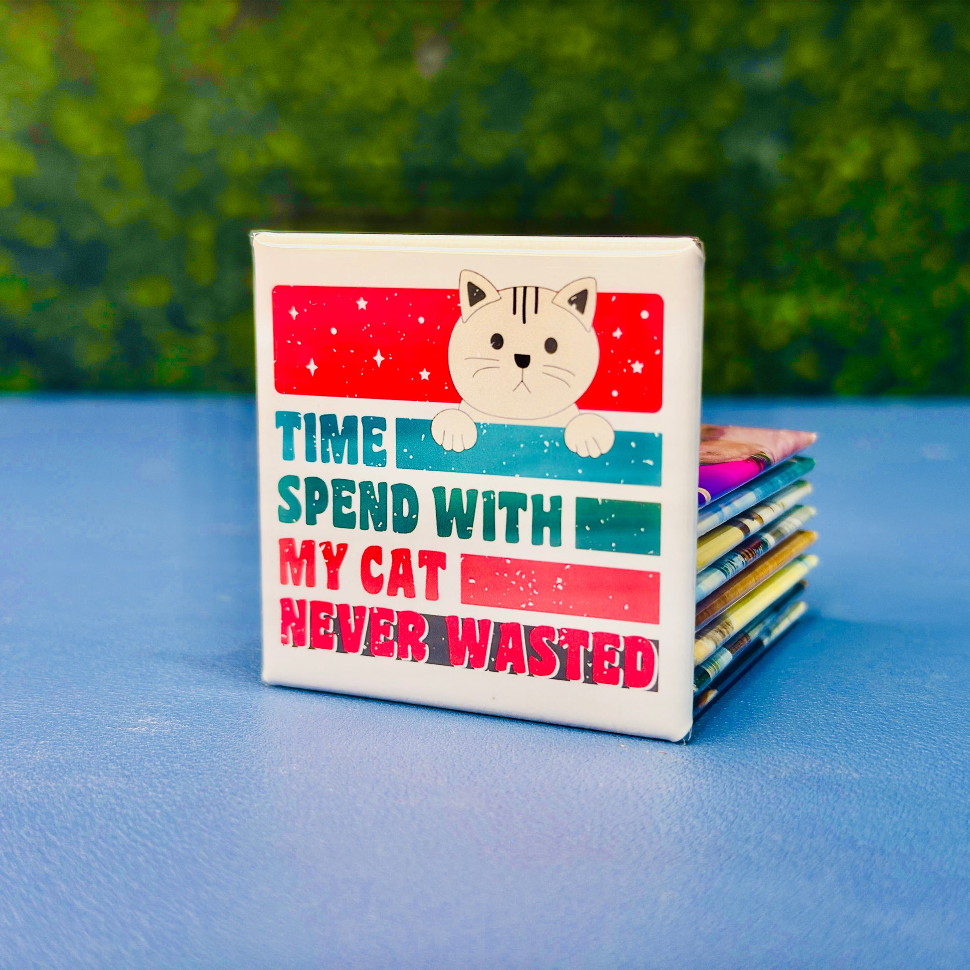 Retro-style square cat magnet featuring a tan cartoon cat and the bold phrase “Time Spend With My Cat Never Wasted” in red, teal, and navy block lettering. A fun and heartfelt gift for cat moms, pet owners, and feline enthusiasts. Perfect for decorating fridges, lockers, or office spaces. Makes a great stocking stuffer, birthday gift, or just-because treat for the cat-obsessed.