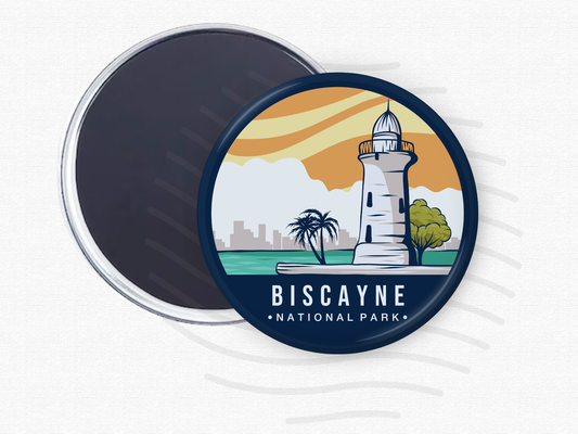 “Round magnet featuring Biscayne National Park with a coastal lighthouse, palm trees, and city skyline under a golden sunset sky.”