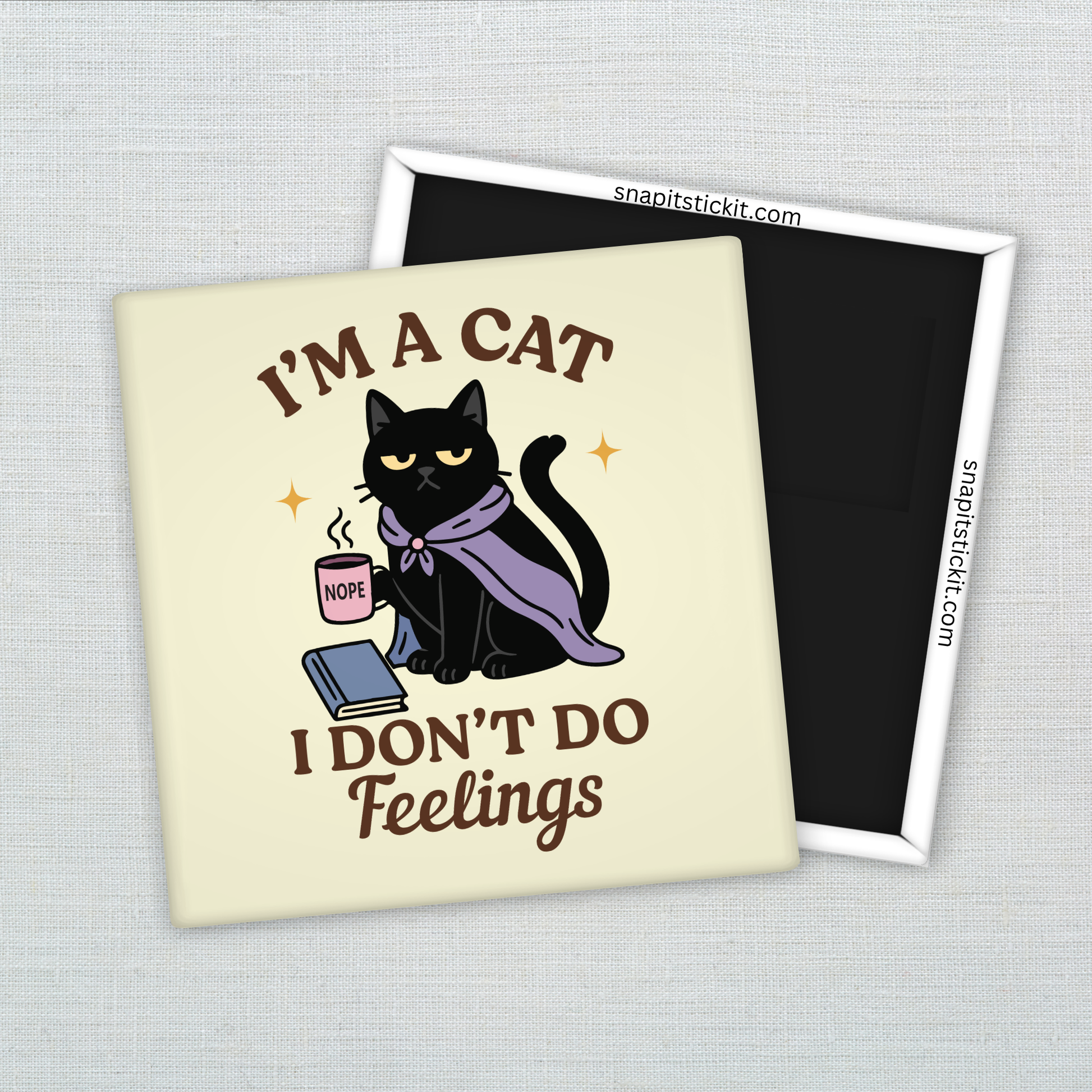 Black cat in purple cloak holding a pink mug labeled “NOPE,” sitting with a book. Surrounded by quote: “I’m a cat. I don’t do feelings.” 2x2 sarcastic magnet.
