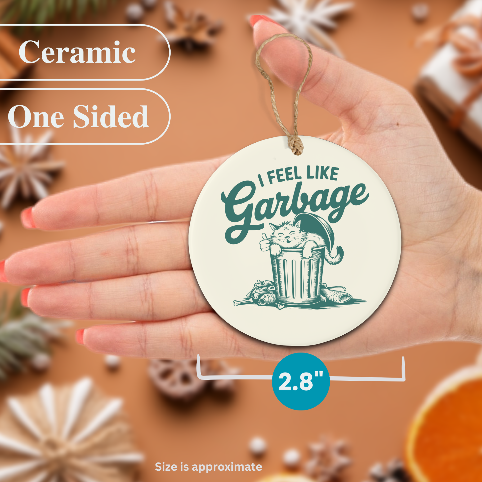 Ceramic Christmas ornament with a cat graphic and text held in a hand, surrounded by decorative items.