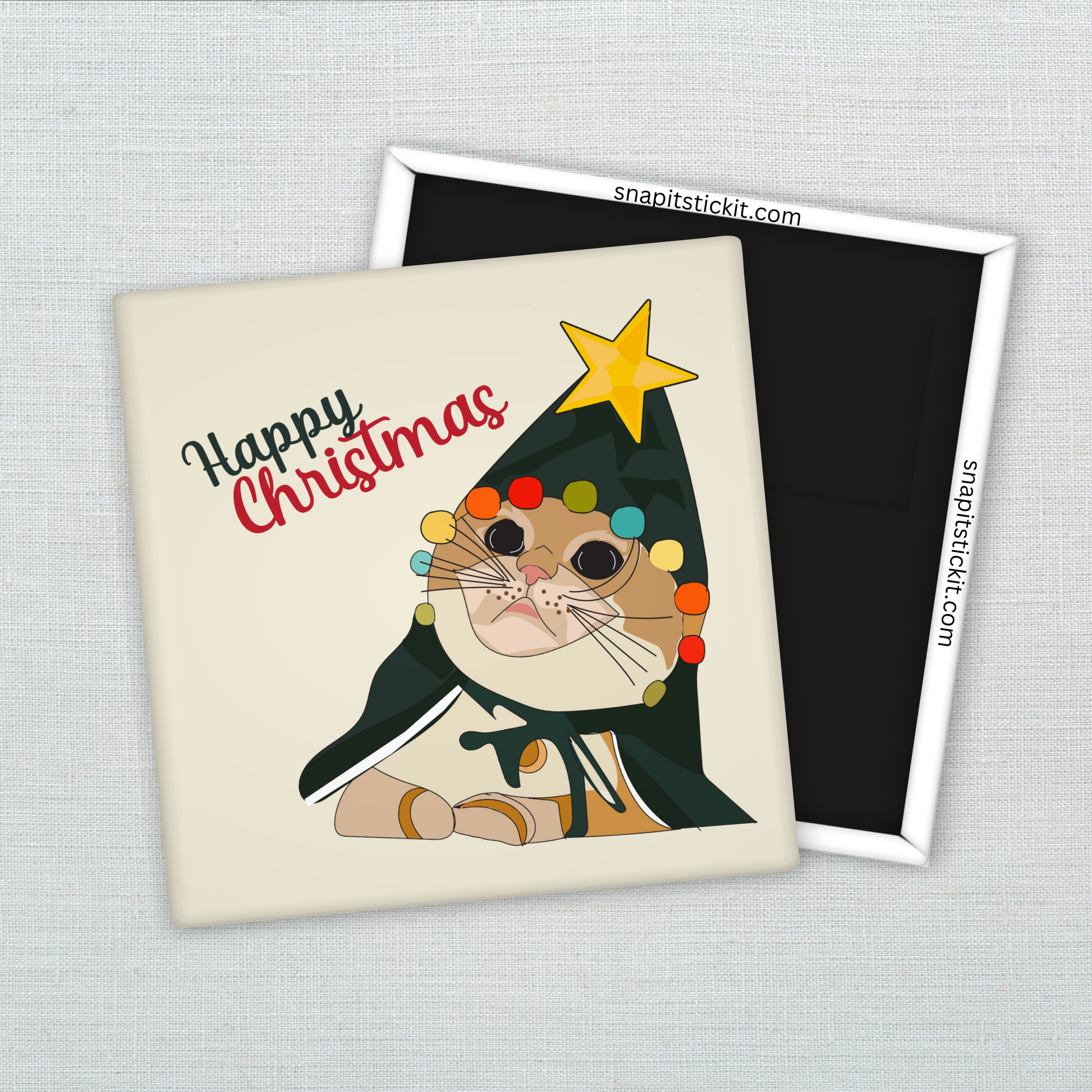 Orange cat dressed as a Christmas tree with tangled lights and a star on its head, under the words “Happy Christmas.” Funny 2x2 holiday magnet.