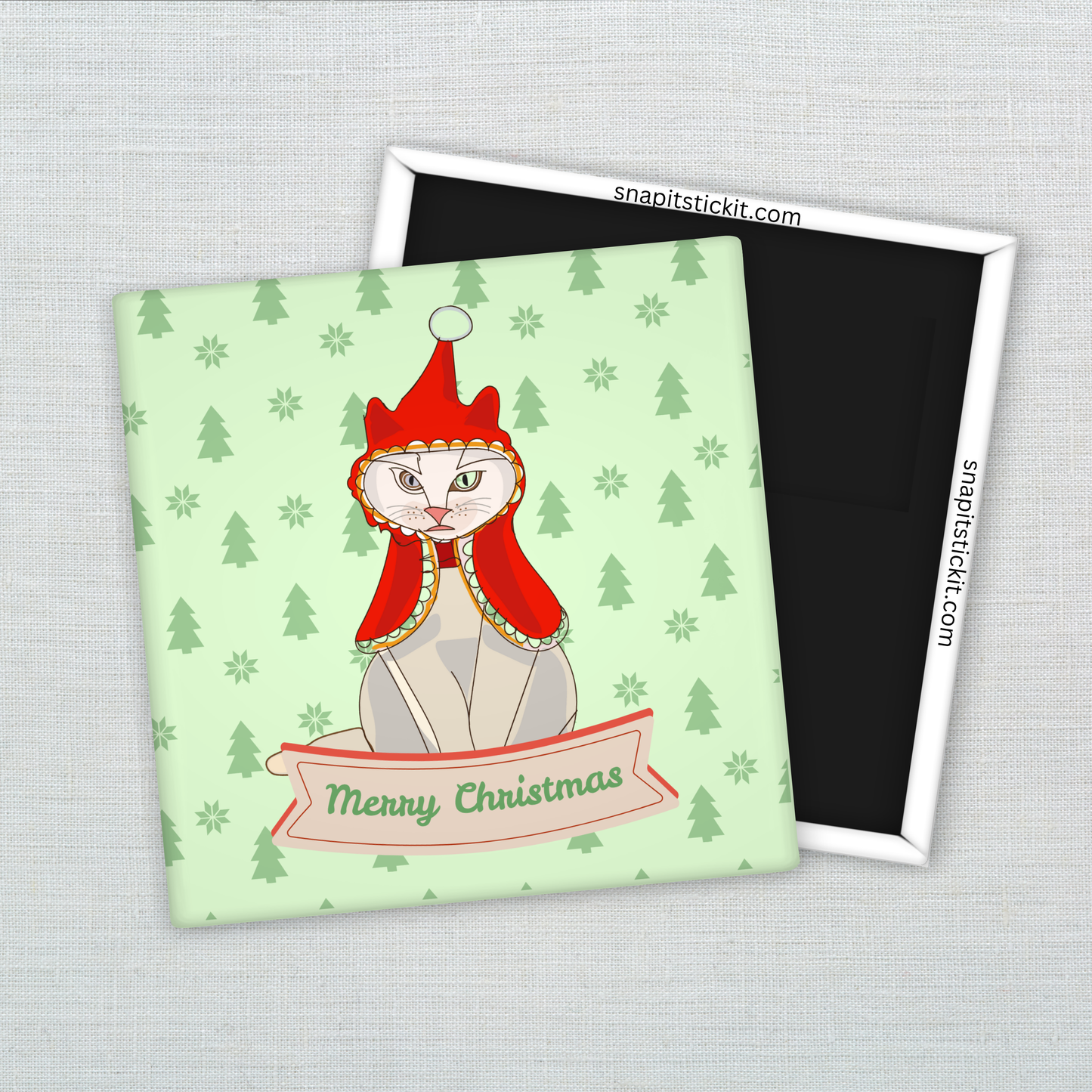 Hairless Sphynx cat wearing a red bonnet, sitting under a “Merry Christmas” banner on a light green background with pine trees. Funny 2x2 holiday magnet.