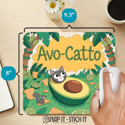 Avocado-themed mouse pad with 'Avo-Catto' text and a hand using a mouse, on a desk with a coffee cup and flowers.