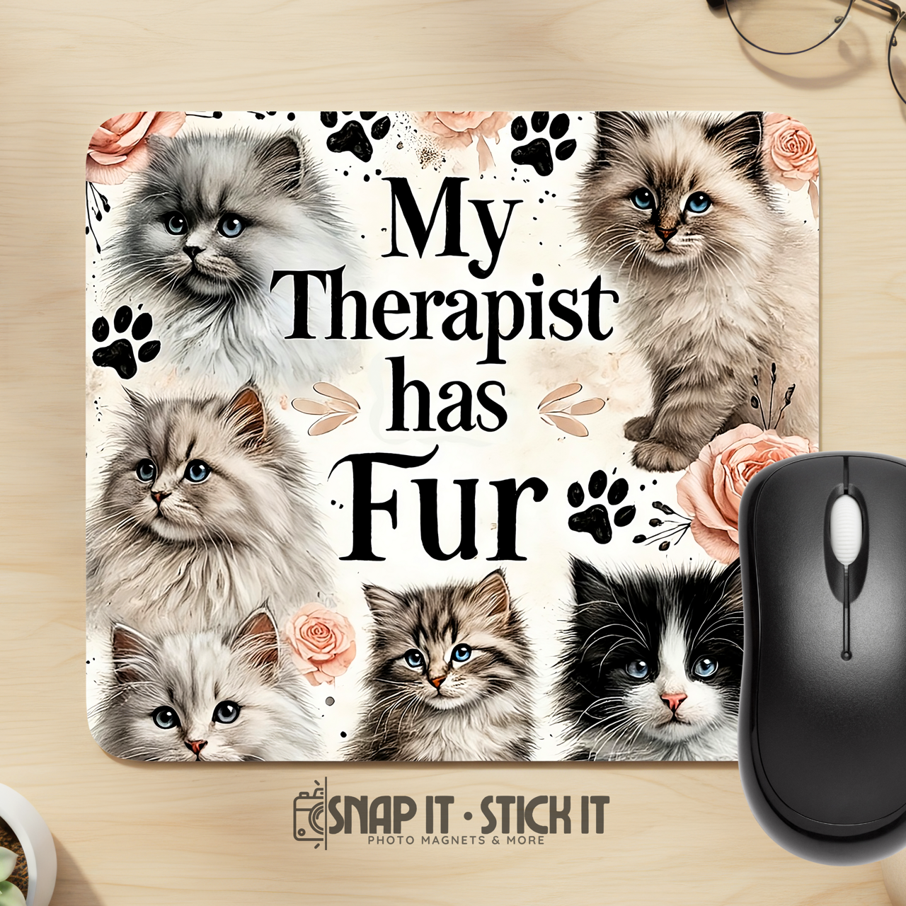 Mouse pad with cat illustrations and text 'My Therapist has Fur' on a wooden surface with a mouse.