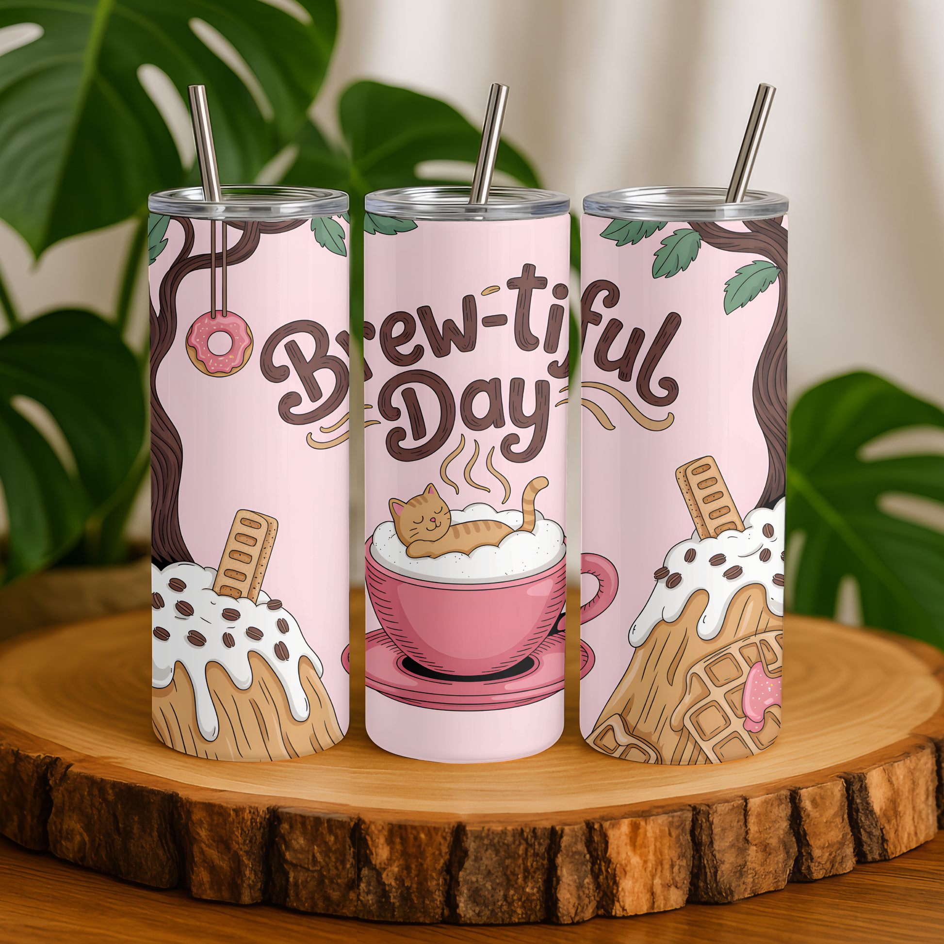 Three insulated tumblers with cartoon designs on a wooden surface with a plant in the background.