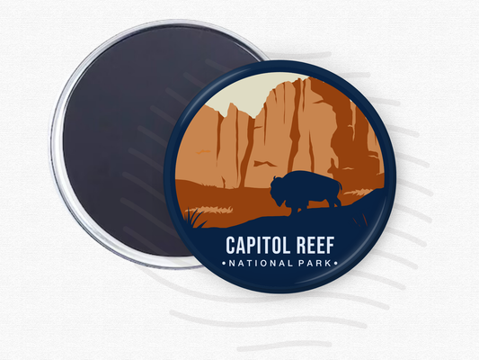 Round magnet featuring Capitol Reef National Park with towering rust-colored cliffs and a dark silhouette of a bison in the foreground.