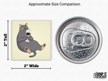 Cat drinking wine magnet size comparison – 2x2” illustrated gray cat with red wine glass next to a soda can top. Hilarious cat fridge magnet, perfect gift for wine moms, pet lovers, or quirky kitchen decor.