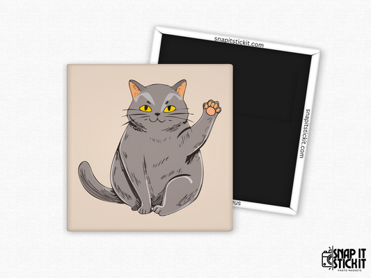 Gray cat waving fridge magnet – 2x2” square magnet featuring a cute cartoon gray cat with yellow eyes and raised paw on a beige background. Strong magnetic back with Snap It Stick It branding. Fun gift for cat lovers and pet parents.