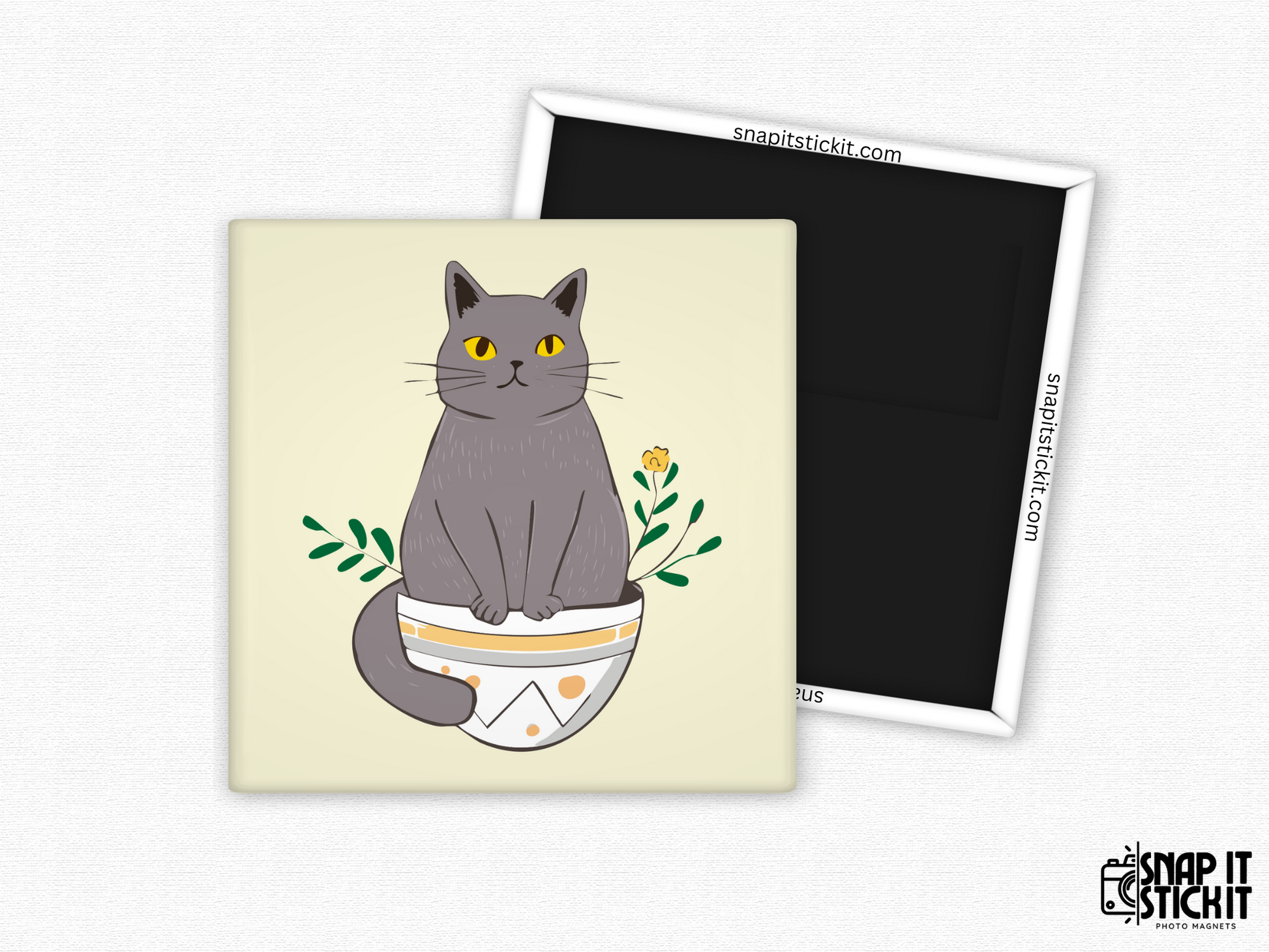 Gray cat in flower pot fridge magnet – 2x2” square magnet featuring a cartoon gray cat with yellow eyes sitting in a decorative plant pot with leaves and a small flower. Cream background with strong magnetic backing and Snap It Stick It branding. Great for cat lovers, plant moms, and whimsical decor fans.