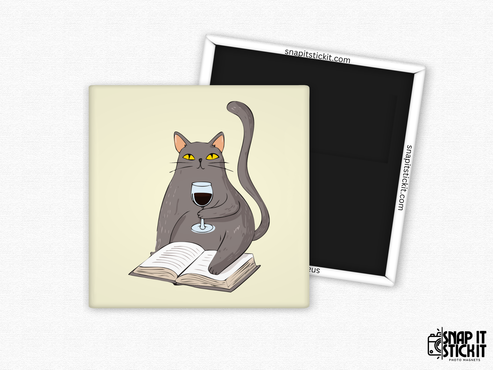 Gray cat with wine and book fridge magnet – 2x2” square magnet featuring a cartoon gray cat sitting on an open book and holding a glass of red wine. Cream background with strong magnetic back and Snap It Stick It branding. Perfect gift for cat lovers, bookworms, and wine moms.
