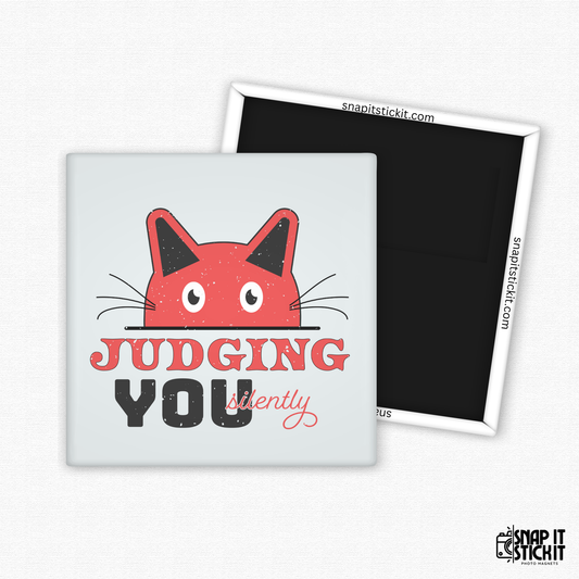 Fridge magnet with a red cat face and text 'Judging You Silently' on a white background.