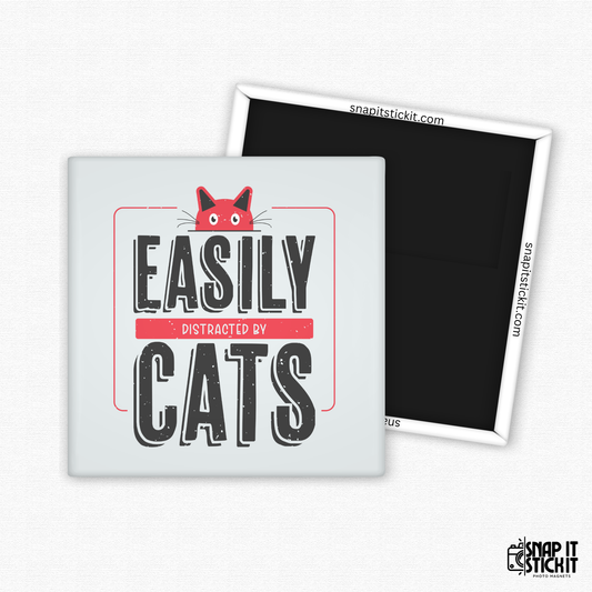 Fridge magnet with 'Easily Distracted by Cats' text and a cat illustration on a white background.