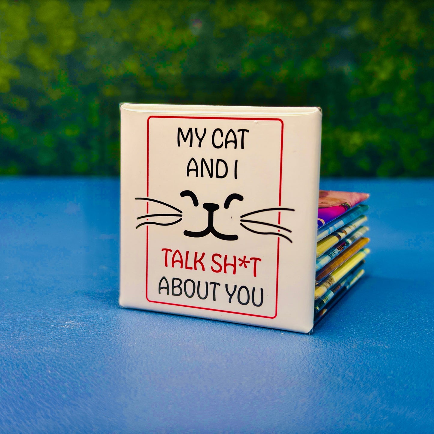 Funny square cat magnet featuring minimalist black whiskers and a cat face with the quote “My Cat and I Talk Sh*t About You.” A sassy, sarcastic gift for cat lovers with a sense of humor. Great for cat moms, pet owners, or anyone who appreciates edgy fridge decor. Perfect for fridges, lockers, offices, or as a gag gift for friends who know cats never keep secrets.
