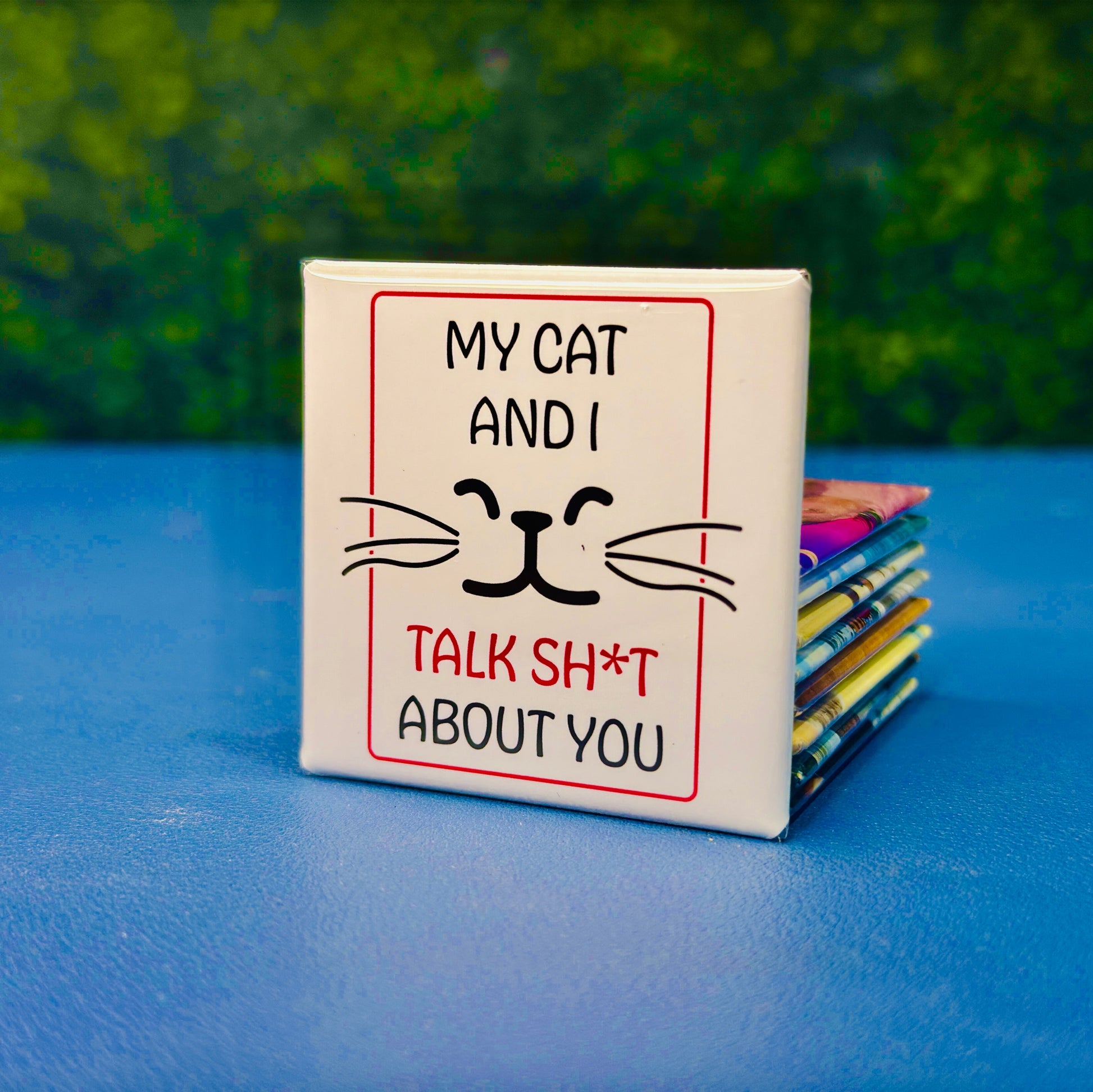 Funny square cat magnet featuring minimalist black whiskers and a cat face with the quote “My Cat and I Talk Sh*t About You.” A sassy, sarcastic gift for cat lovers with a sense of humor. Great for cat moms, pet owners, or anyone who appreciates edgy fridge decor. Perfect for fridges, lockers, offices, or as a gag gift for friends who know cats never keep secrets.
