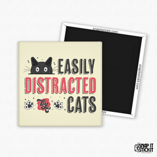 Fridge magnet with a black cat illustration and text 'Easily Distracted by Cats' on a beige background.