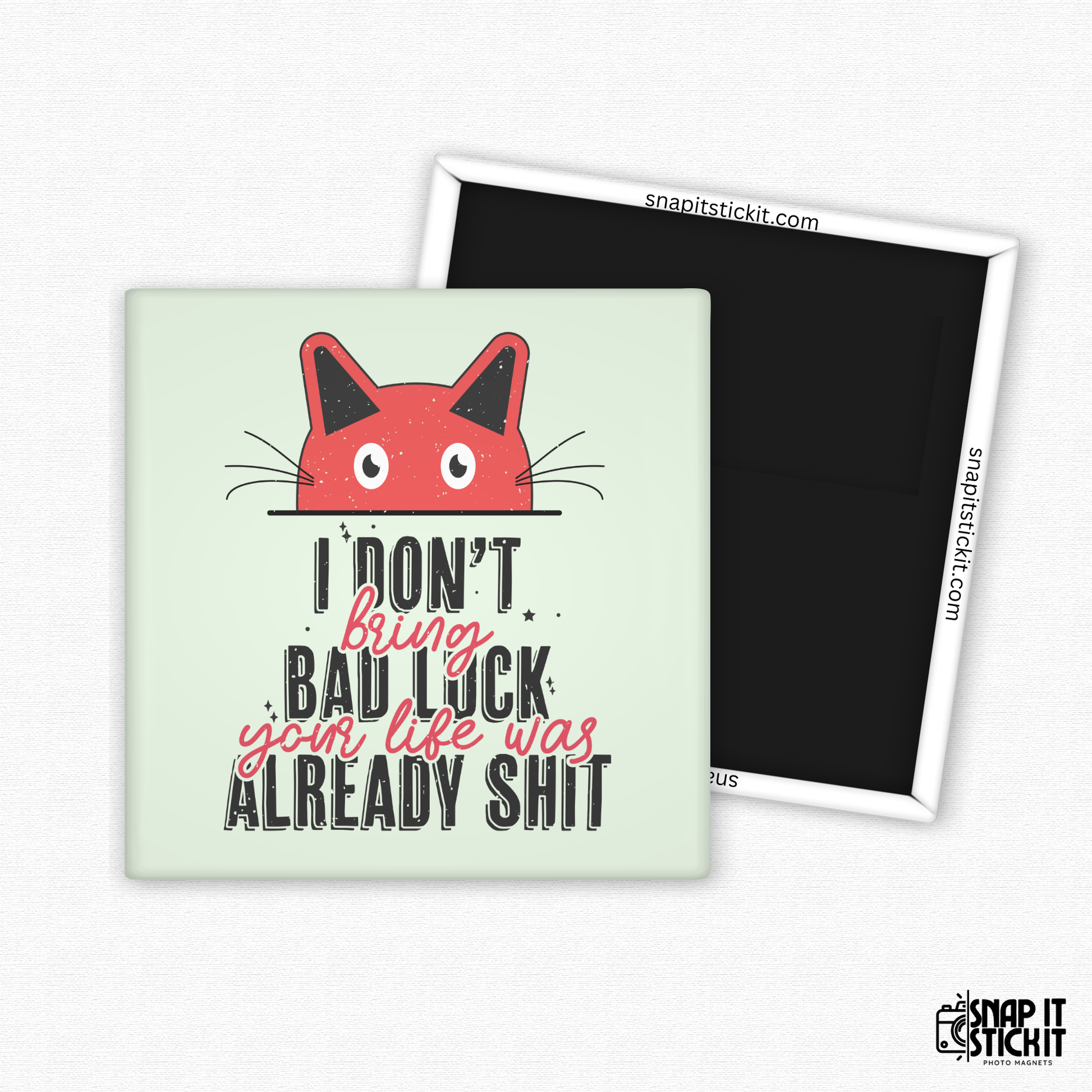 Fridge magnet with a red cat illustration and text on a light green background