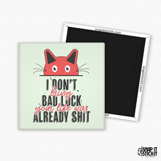 Fridge magnet with a red cat illustration and text on a light green background