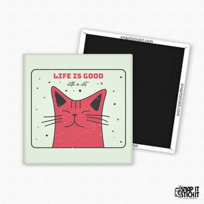 Fridge magnet with a pink cat illustration and 'Life is good with a cat' text on a light green background.