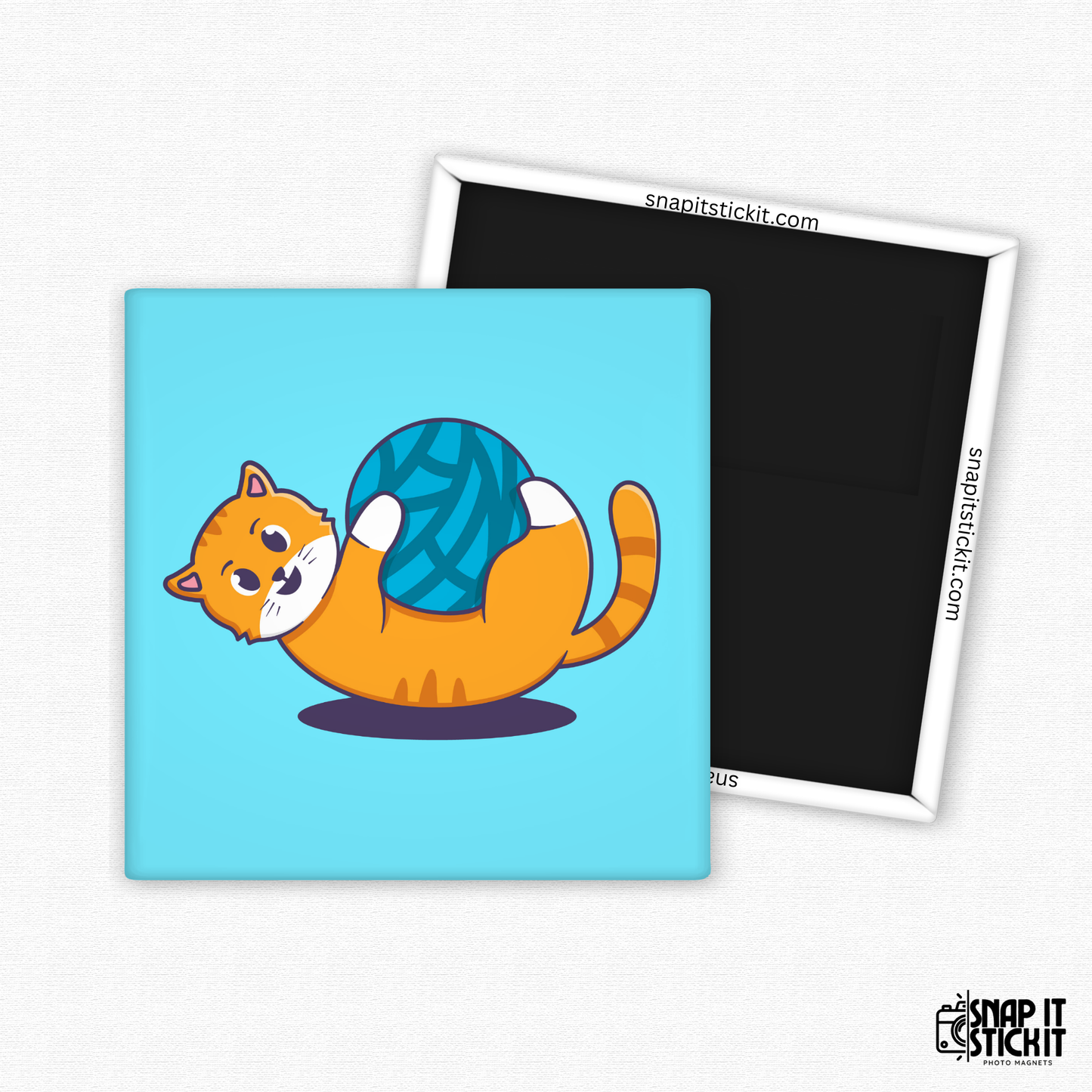 Fridge magnet with a cartoon cat holding a ball of yarn on a blue background