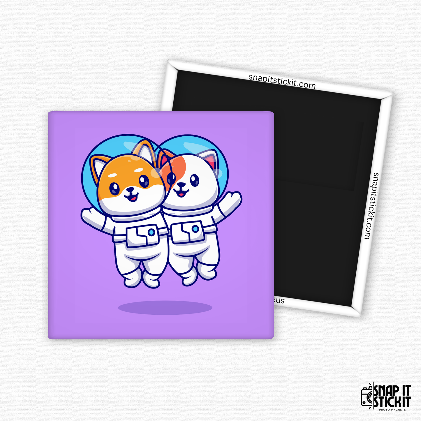 Two cartoon-style cats in astronaut suits floating side by side in space, against a purple background. 2x2 funny cat magnet. Handmade by Snap It Stick It.