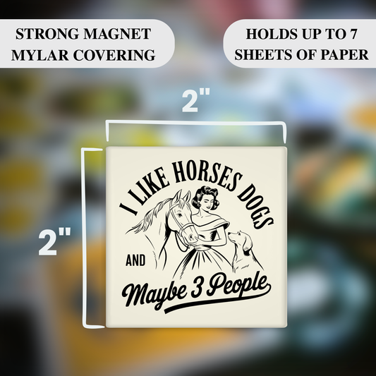 Magnet with 'I Like Horses, Dogs, and Maybe 3 People' text and measurements on a blurred background