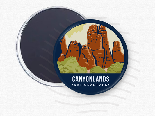 Round magnet featuring Canyonlands National Park with towering red rock formations and green shrubs beneath a light yellow sky.